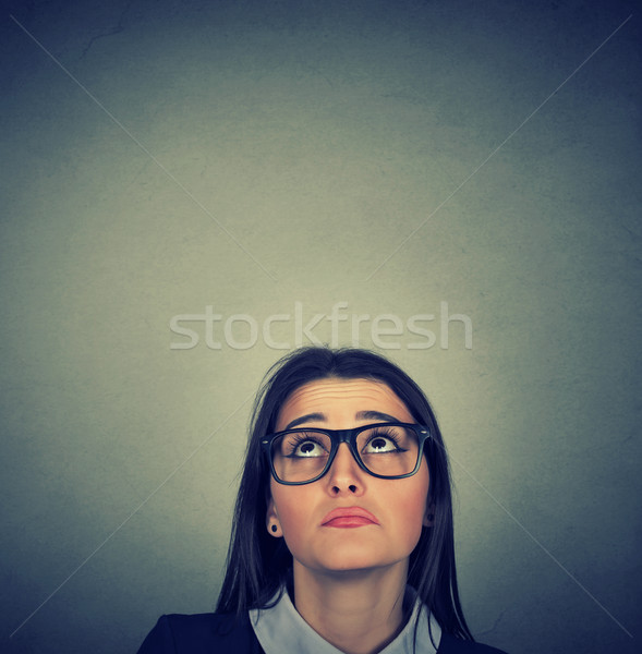 Young skeptical woman looking up isolated Stock photo © ichiosea