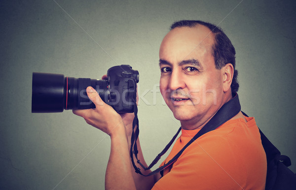 Side profile middle aged man using professional camera Stock photo © ichiosea