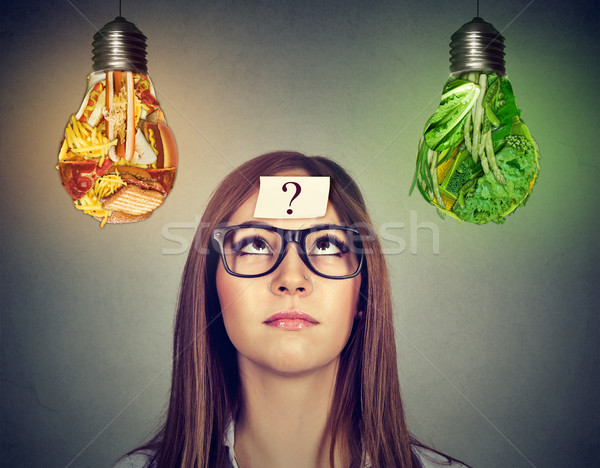 Nő néz egészségtelen étel zöld zöldségek villanykörte Stock fotó © ichiosea