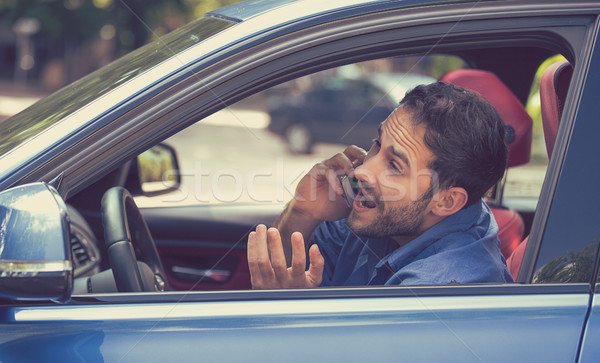man talking on mobile phone while dangerously driving car Stock photo © ichiosea