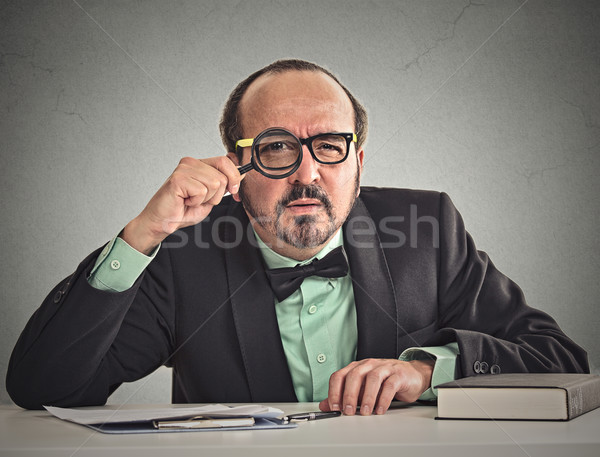businessman skeptically looking at you through magnifying glass  Stock photo © ichiosea