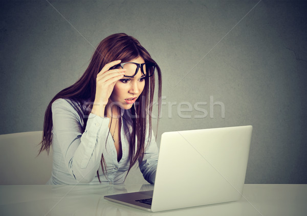 woman with glasses having eyesight problems confused with laptop  Stock photo © ichiosea