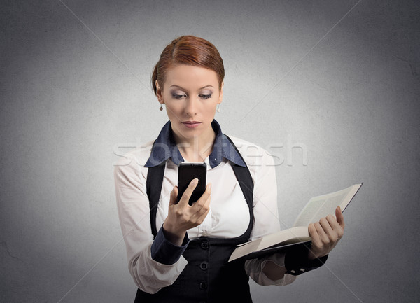 woman reading news on smart phone holding book Stock photo © ichiosea