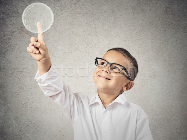 Boy with glasses pushing digital button with copy space Stock photo © ichiosea