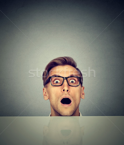 surprised businessman peeking from under the table  Stock photo © ichiosea