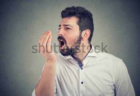 disgusted man with finger in mouth displeased about to throw up  Stock photo © ichiosea