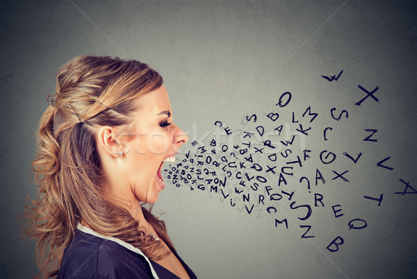 Angry woman screaming with alphabet letters flying out of wide open mouth  Stock photo © ichiosea