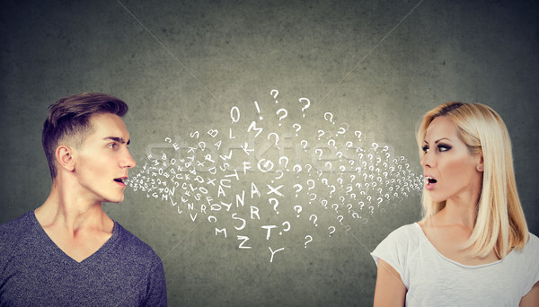 Language barrier concept. Handsome man talking to an attractive woman with many questions Stock photo © ichiosea