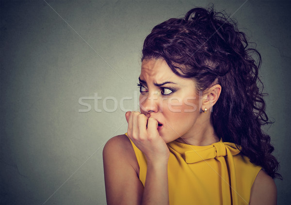Stock photo: scared nervous woman biting her fingernails anxious 