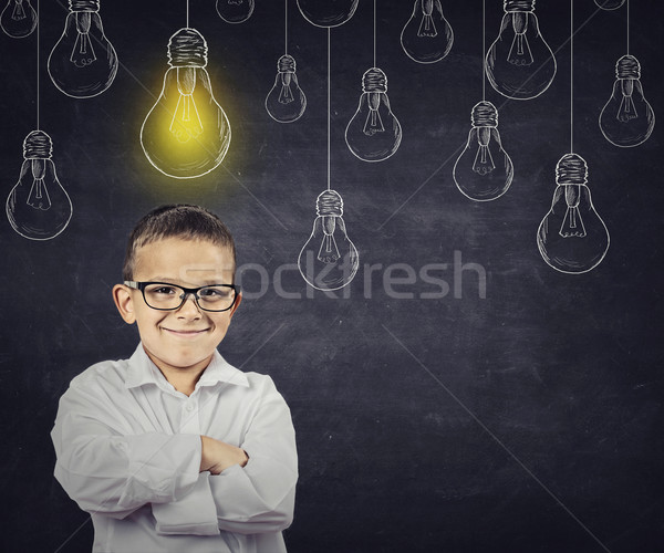 Big idea. Smart boy with solution lightbulb above head Stock photo © ichiosea