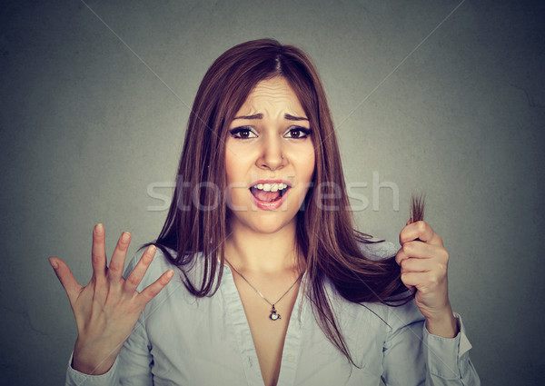 Frustrated woman surprised she is losing hair split ends Stock photo © ichiosea