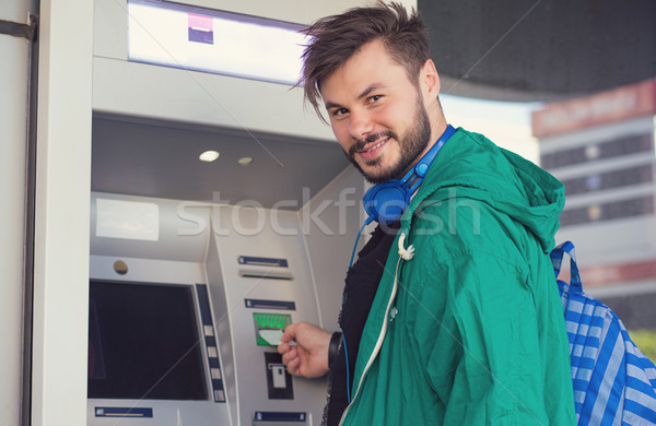 Content man using ATM machine successfully Stock photo © ichiosea