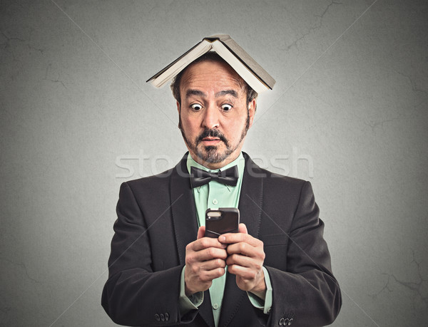 surprised man reading news on smart phone  Stock photo © ichiosea