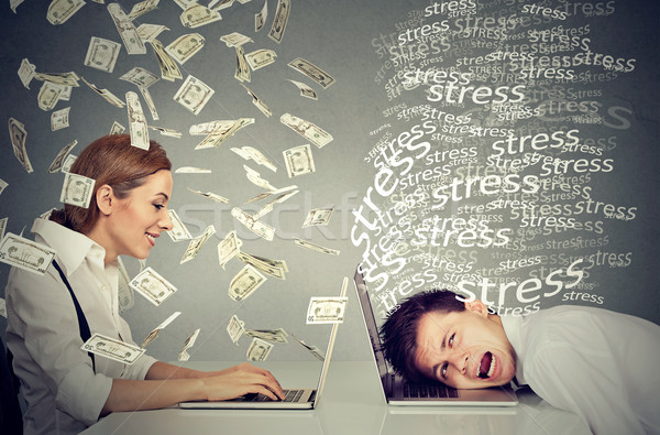 Woman under cash rain working on laptop next to stressed man Stock photo © ichiosea