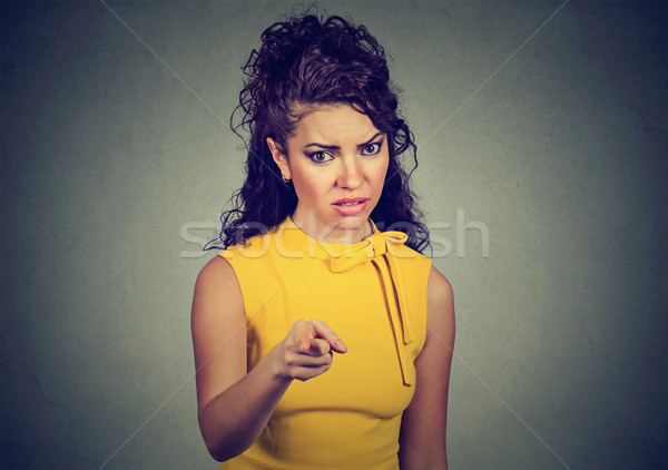 Displeased angry woman pointing finger at camera   Stock photo © ichiosea