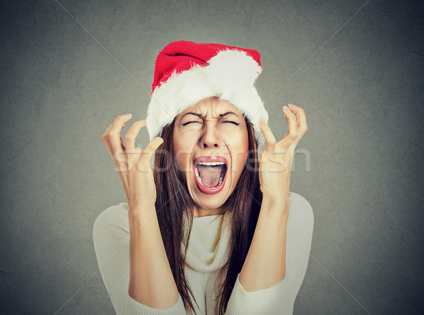 worried stressed overwhelmed woman wearing santa claus hat screaming  Stock photo © ichiosea