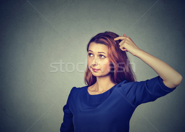 confused thinking woman bewildered scratching head seeks solution Stock photo © ichiosea