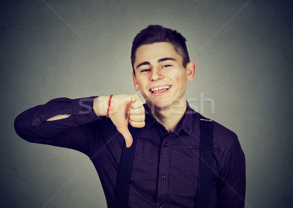 sarcastic man showing thumbs down happy someone made mistake  Stock photo © ichiosea