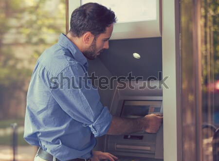 Fiatal boldog férfi bankautomata pénz kéz Stock fotó © ichiosea