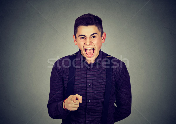Angry man screaming pointing finger at someone  Stock photo © ichiosea