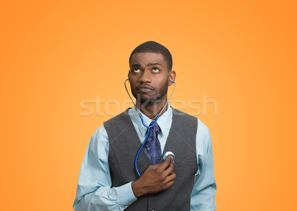 Executive man listening  to his heart, self criticism concept Stock photo © ichiosea