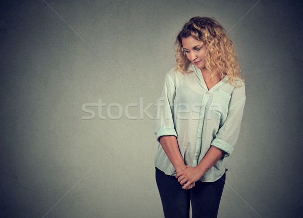 Nieśmiała młoda kobieta patrząc w dół kontakt z oczami stałego odizolowany Zdjęcia stock © ichiosea