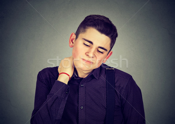 Young man having neck pain Stock photo © ichiosea