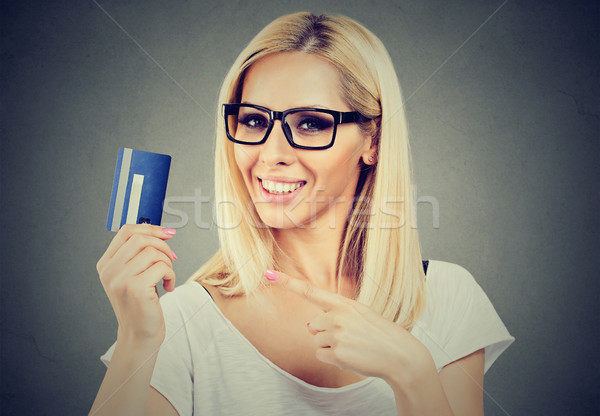 Happy cheerful woman pointing at credit card Stock photo © ichiosea