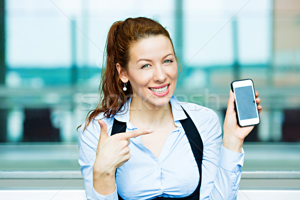 Stock photo: Satisfied customer pointing at her smart phone