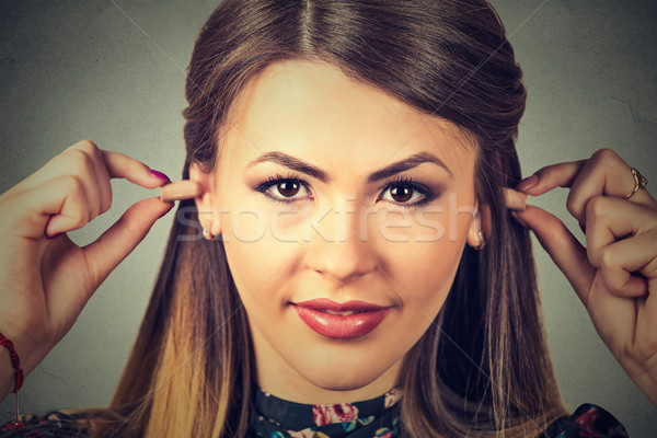 Noise control. Young woman with ear plugs Stock photo © ichiosea