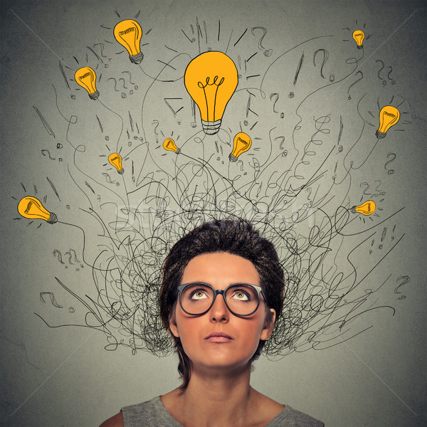 thinking worried woman with question signs and light idea bulbs above head  Stock photo © ichiosea