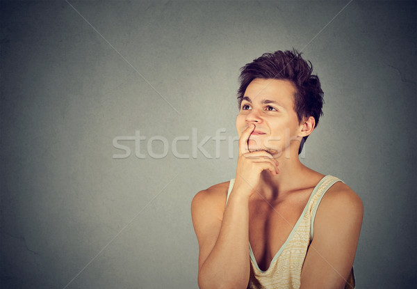 Stock photo: Happy young man thinking dreaming looking up 