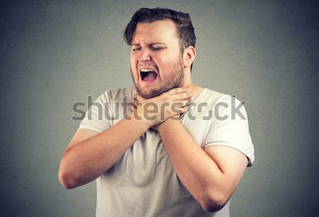 Adult man suffering from severe sharp heartache, chest pain Stock photo © ichiosea