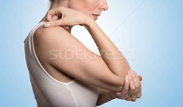 Arm pain and injury concept. Closeup side profile woman with painful elbow Stock photo © ichiosea