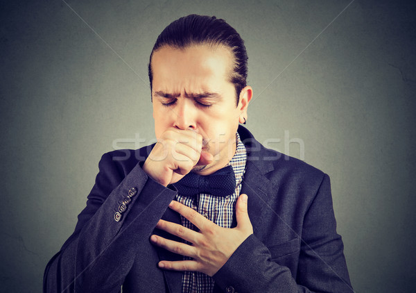 Man coughing heavily on gray Stock photo © ichiosea