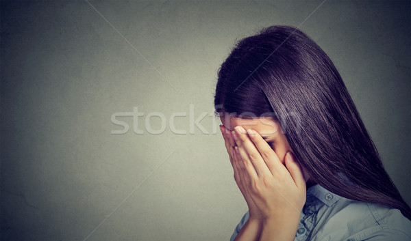 Side profile of a sad woman covering her face with hands  Stock photo © ichiosea