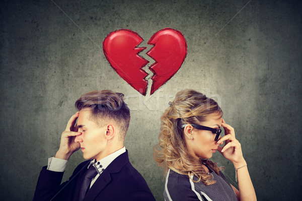 Rift in relations. Sad couple standing back to back with broken heart in-between  Stock photo © ichiosea