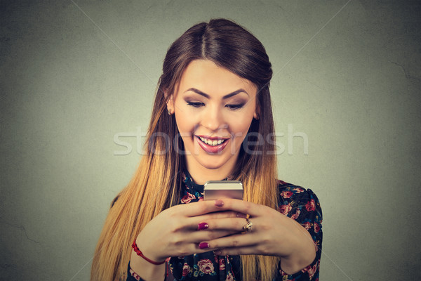 portrait of a smiling beautiful woman texting on her mobile phone
 Stock photo © ichiosea