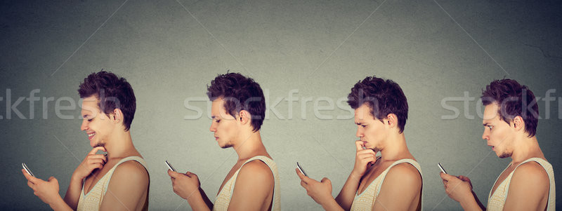 Young man expressing different emotions using his mobile phone  Stock photo © ichiosea