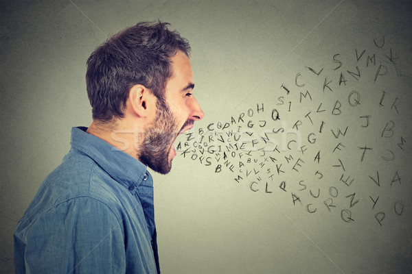 angry man screaming with alphabet letters flying out of wide open mouth Stock photo © ichiosea