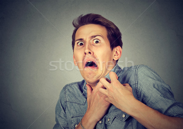 man looking shocked scared trying to protect himself from unpleasant  Stock photo © ichiosea