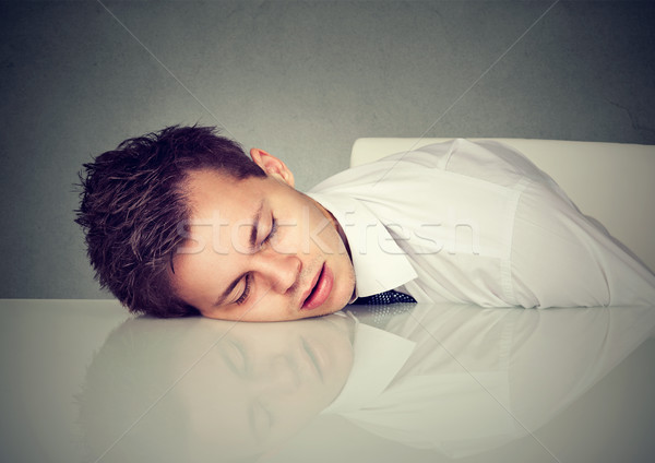 Stock photo: Man sleeping on a desk office table 