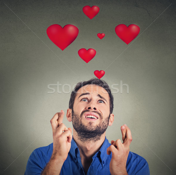 Fiatalember szeretet készít kívánság izolált szürke Stock fotó © ichiosea