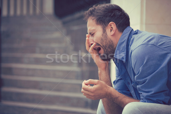 sorrowful crying man sitting on steps outdoors  Stock photo © ichiosea