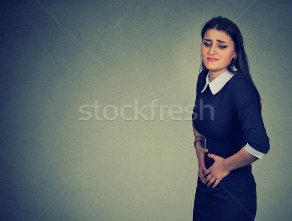  woman having abdominal pain upset stomach or menstrual cramps Stock photo © ichiosea