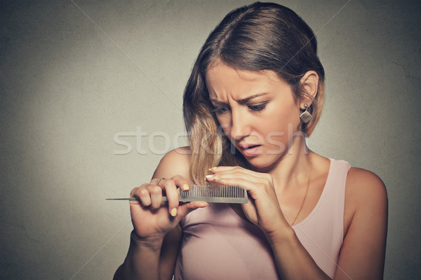 frustrated young woman surprised she is losing hair, noticed split ends Stock photo © ichiosea
