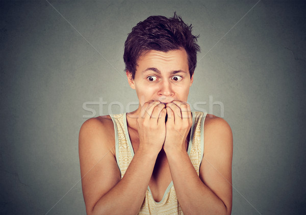 Portrait anxious young man biting his nails fingers freaking out Stock photo © ichiosea