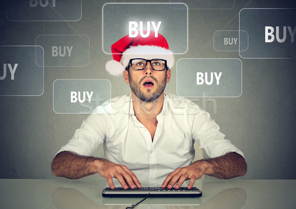 Christmas man in santa hat buying stuff online. Holiday shopping  Stock photo © ichiosea