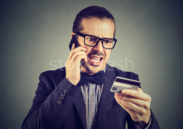 Screaming man solving problems with credit card Stock photo © ichiosea