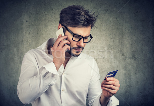 Man making call holding credit card Stock photo © ichiosea